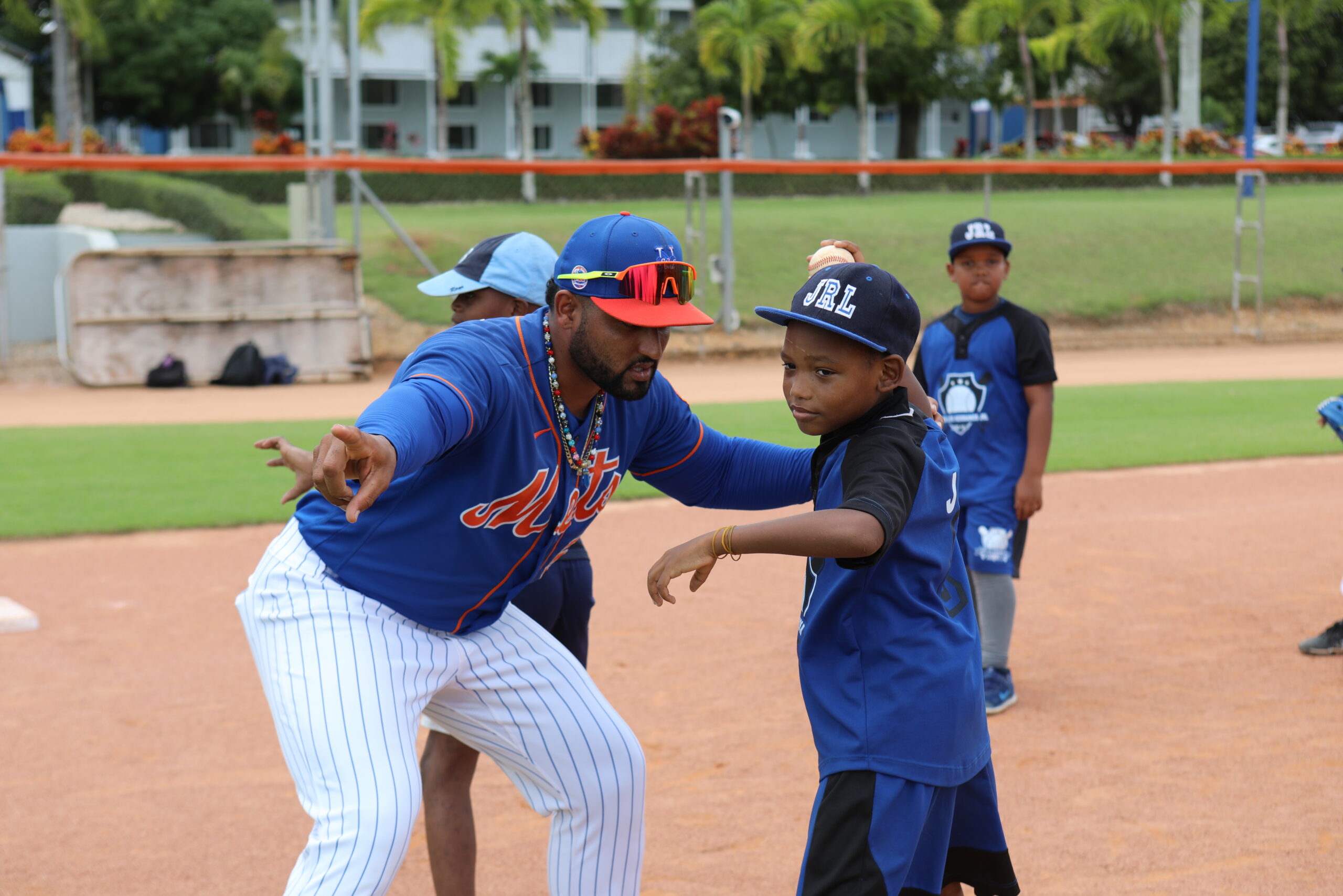 man teaching child how to play baseball
